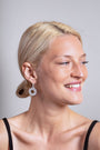 model wears Geometric Statement Silver Hoop Earrings