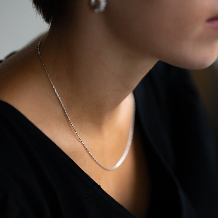 model wears silver barleycorn dainty chain necklace