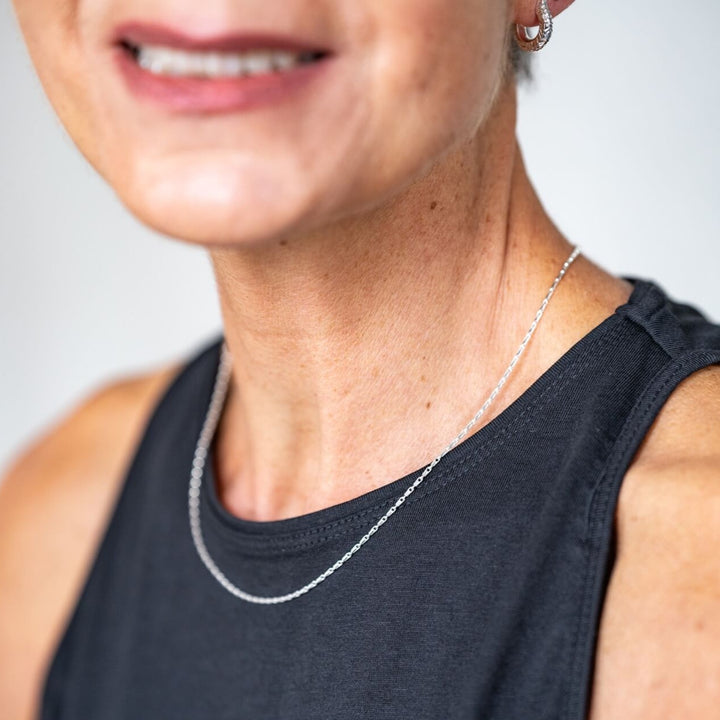 model wears silver barleycorn dainty chain necklace