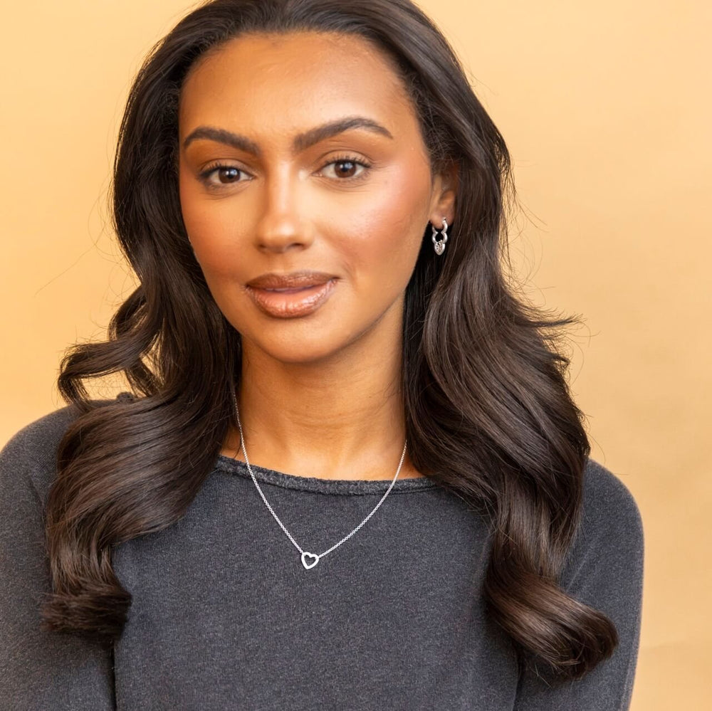 model wears silver brushed heart connector necklace on rolo chain - Claire Hill Designs