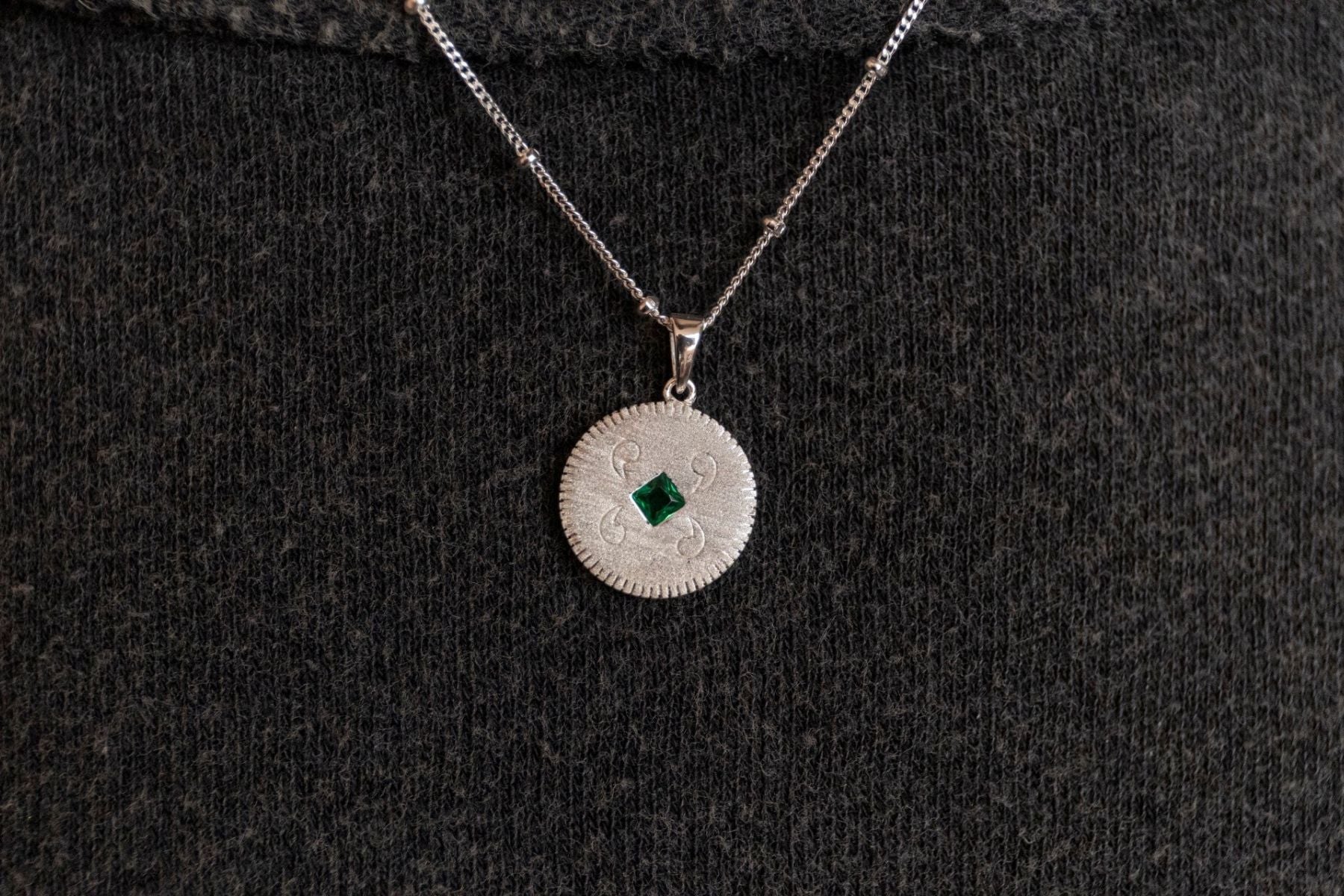 model wears Lovespoon Silver Charm Pendant necklace - close up