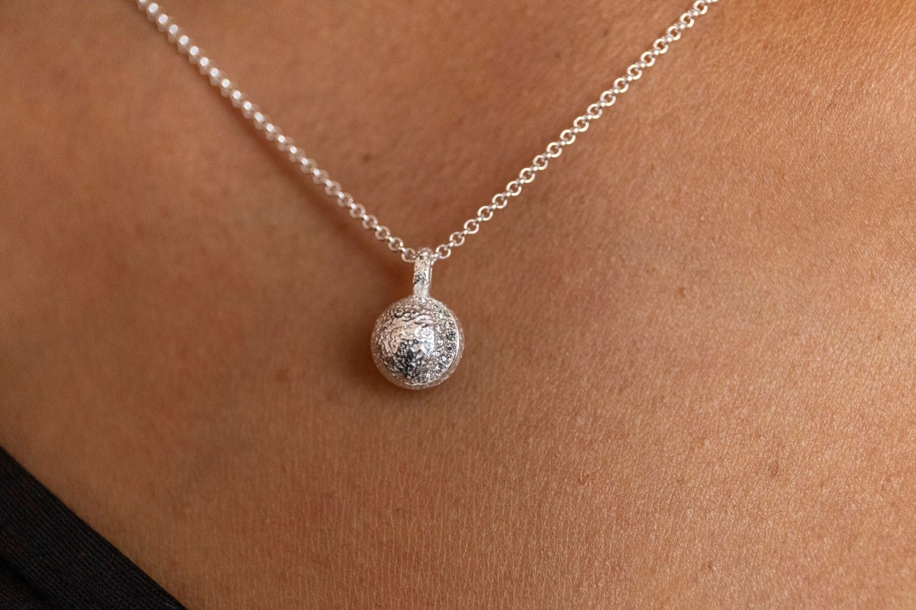 model wears silver moon charm necklace - close up