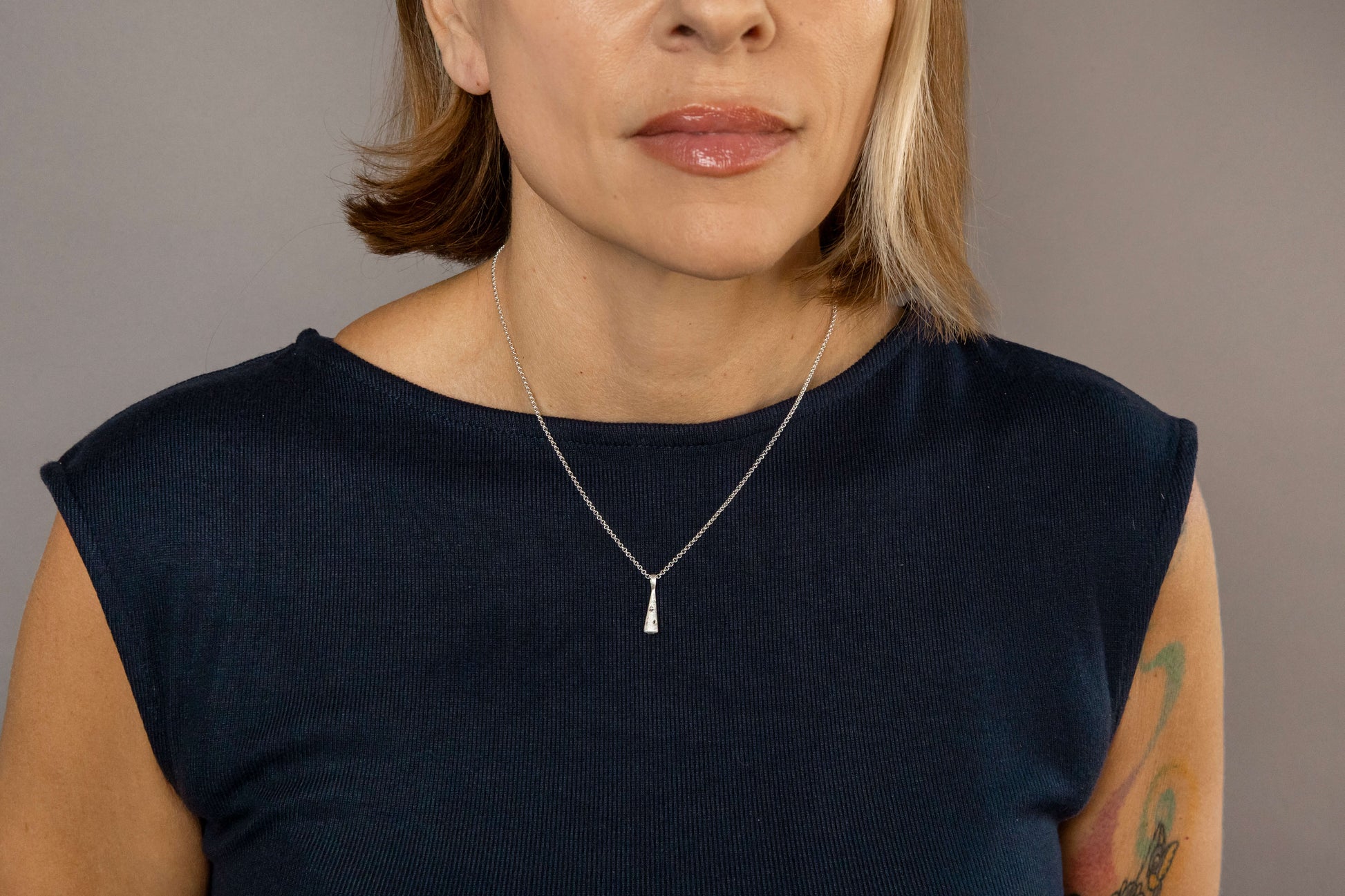 model wears silver comet charm necklace 