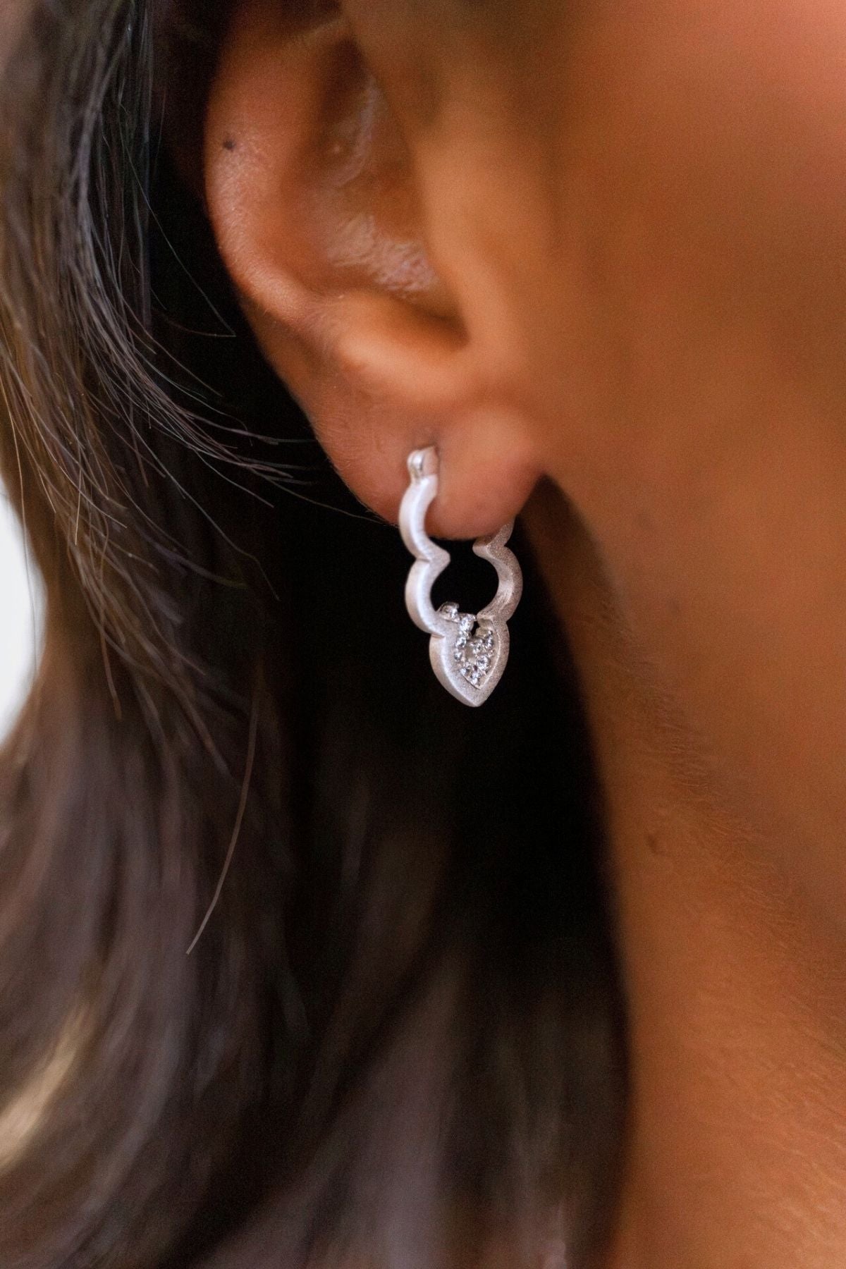 model wears silver sparkly cloud hoop earrings
