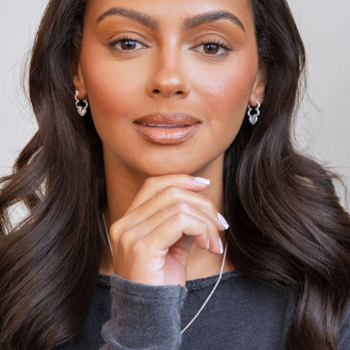 model wears silver sparkly cloud hoop earrings
