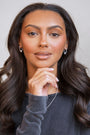 model wears silver sparkly cloud hoop earrings
