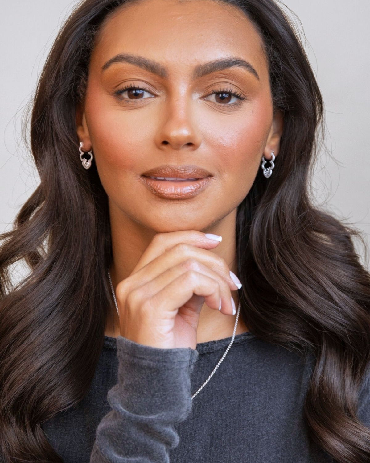 model wears silver sparkly cloud hoop earrings
