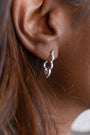 model wears silver sparkly cloud hoop earrings
