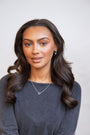 model wears silver heart connector necklace
