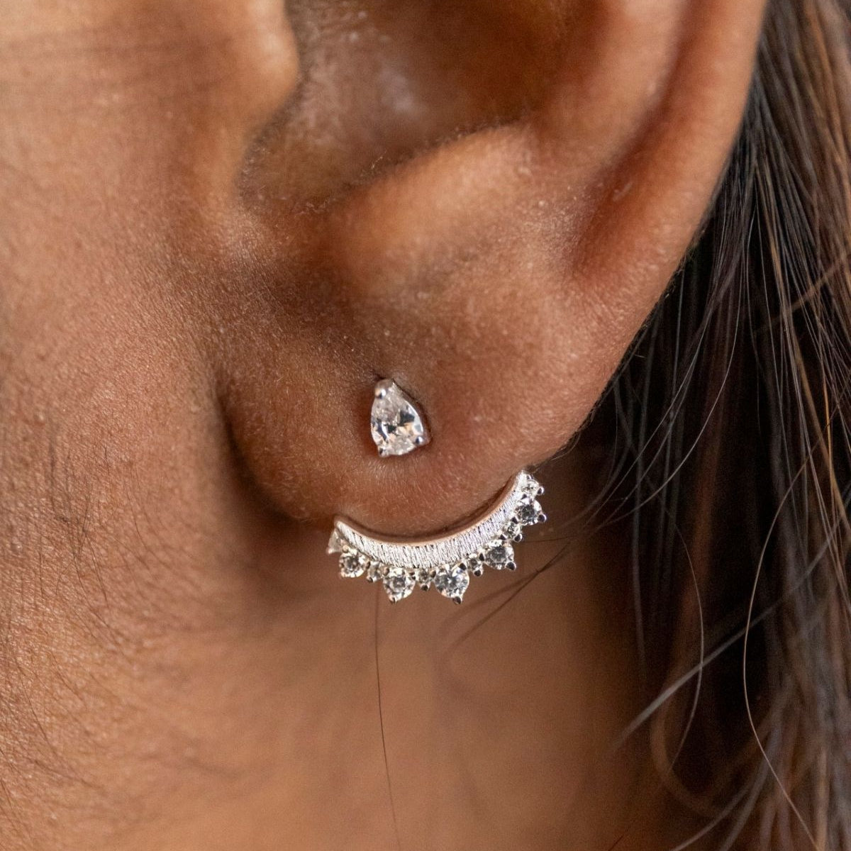 model wears sparkly crescent moon silver ear jacket earrings 