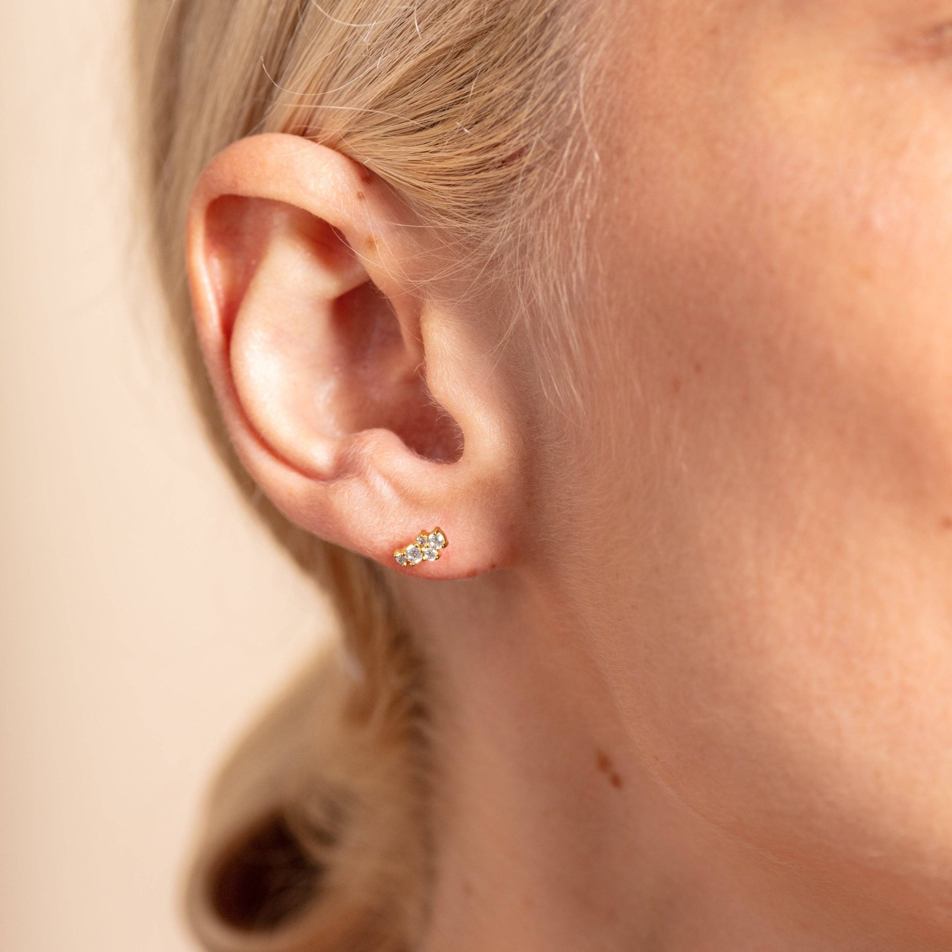 model wears Galaxy Sparkly cubic zirconia Gold Stud Earrings