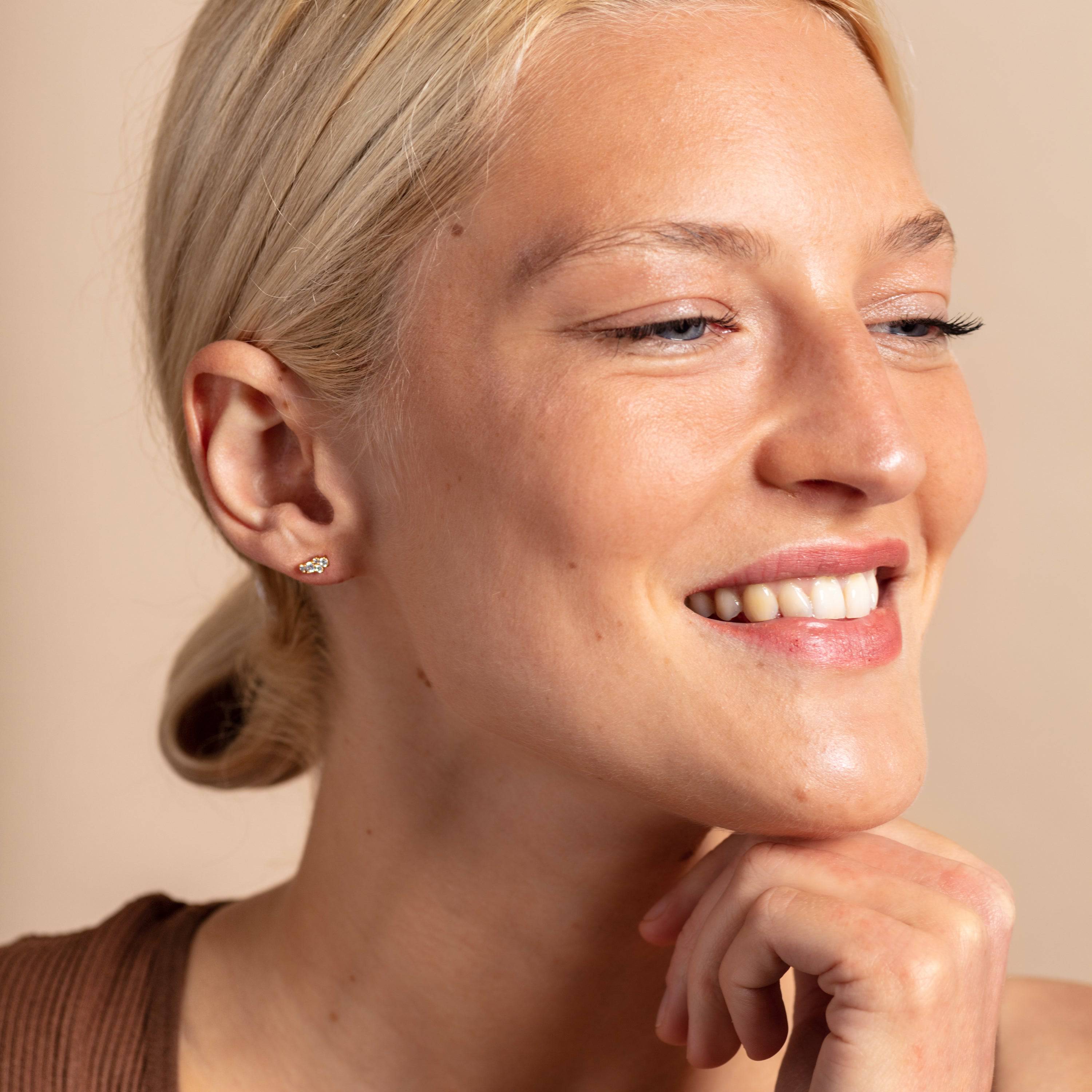 model wears Galaxy Sparkly cubic zirconia Gold Stud Earrings