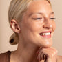 model wears Galaxy Sparkly cubic zirconia Gold Stud Earrings