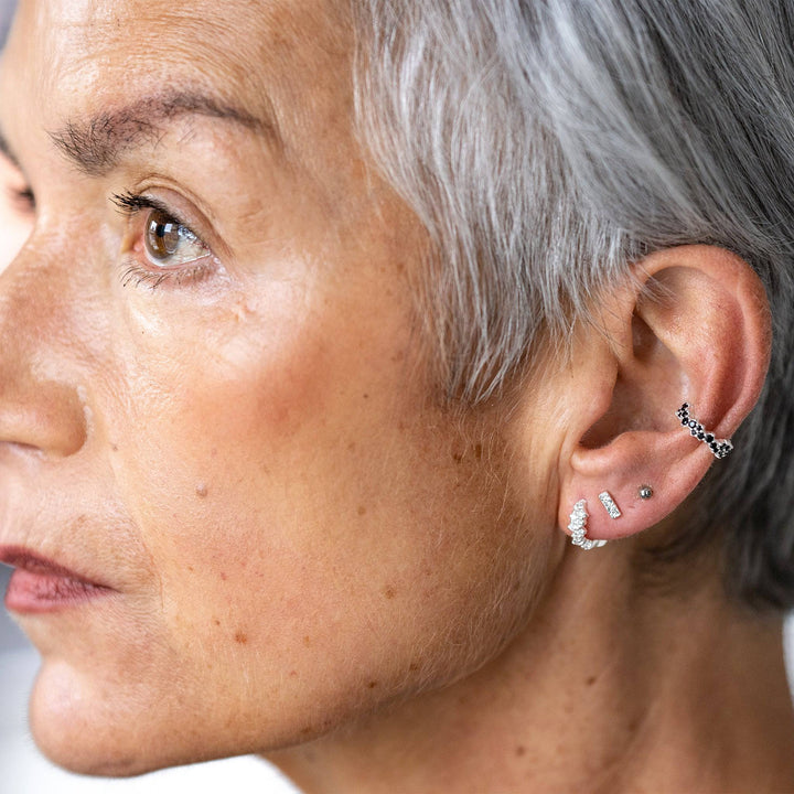 model wears Galaxy Sparkly Silver Scatter Huggie Earrings