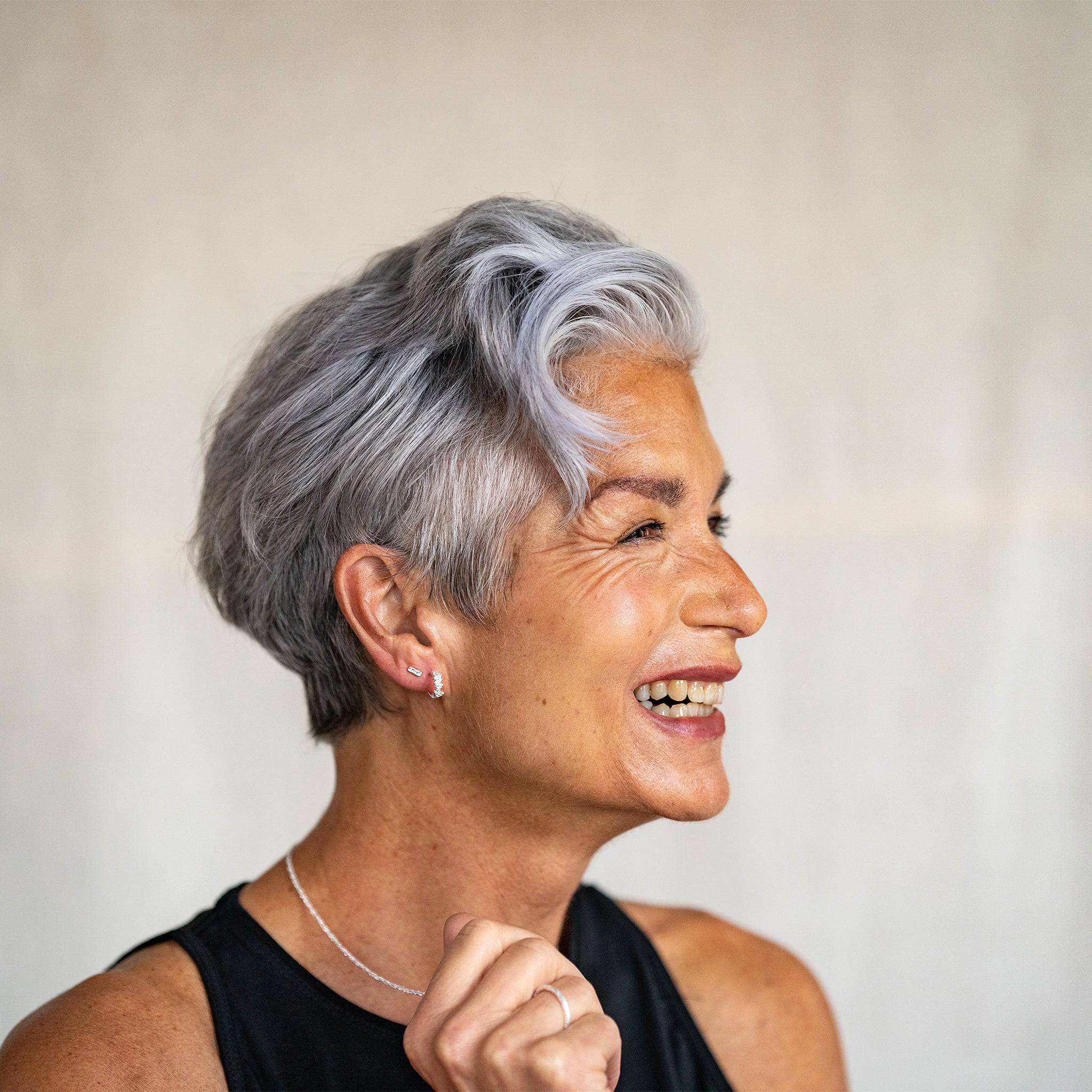 model wears Galaxy Sparkly Silver Scatter Huggie Earrings