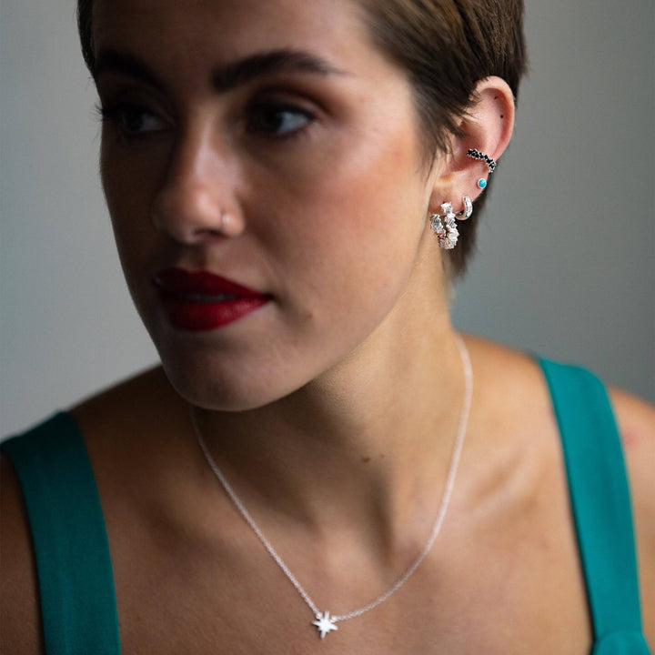 model wears Statement Sparkly Silver Baguette Hoop Earrings (20mm) and silver ear stack