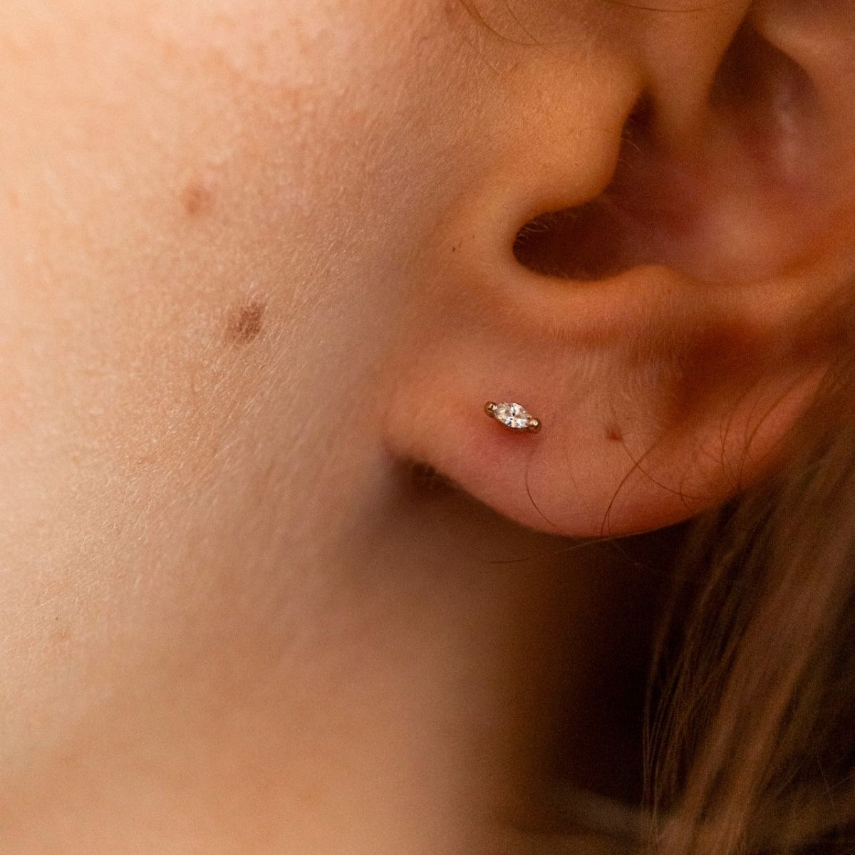 model wears Clear Cubic Zirconia Gold Labret Earring