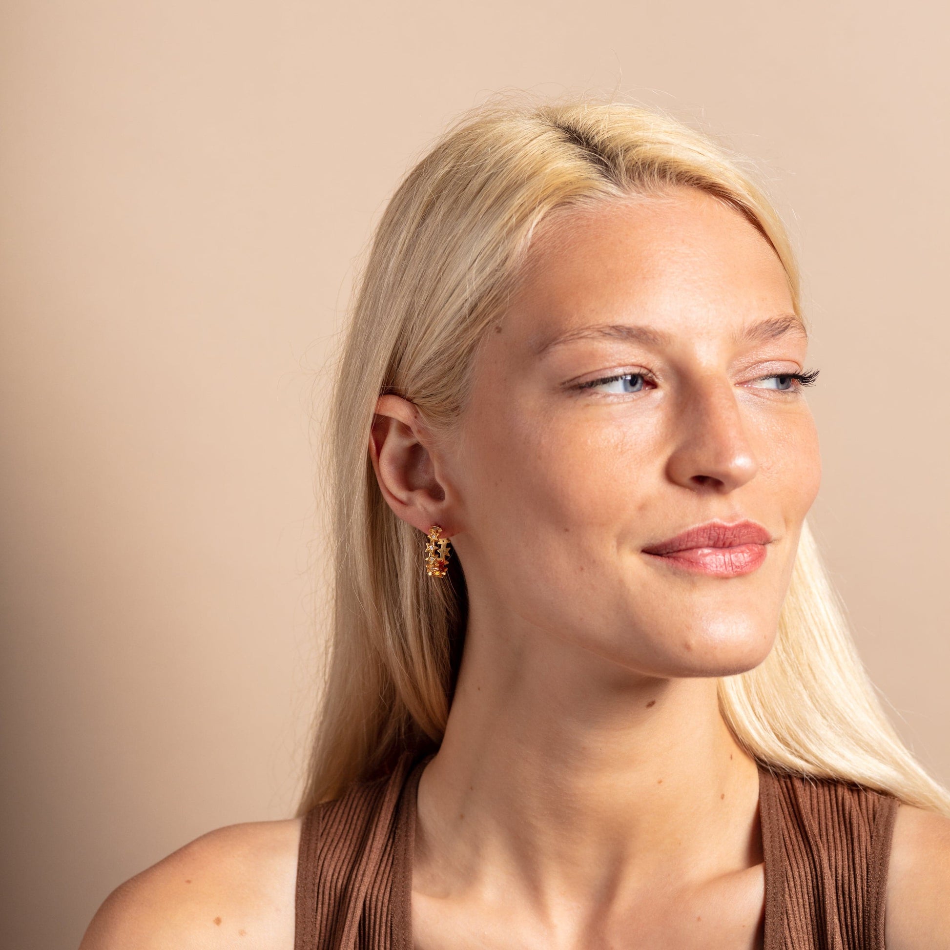 model wears Sparkly Star Statement Gold Hoop Earrings