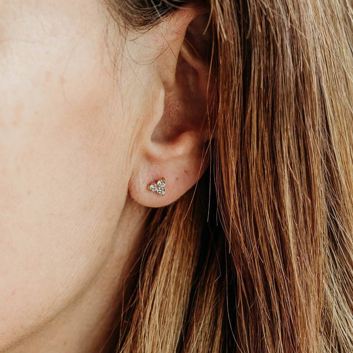 model wears Triple Sparkly Gold Mini Stud Earrings - close up