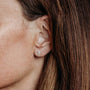 Close up of model wearing Triple Sparkly Silver Mini Stud Earrings