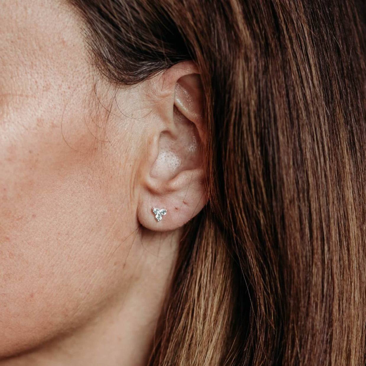 Close up of model wearing Triple Sparkly Silver Mini Stud Earrings
