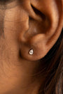 model wears silver ear jacket earrings studs 
