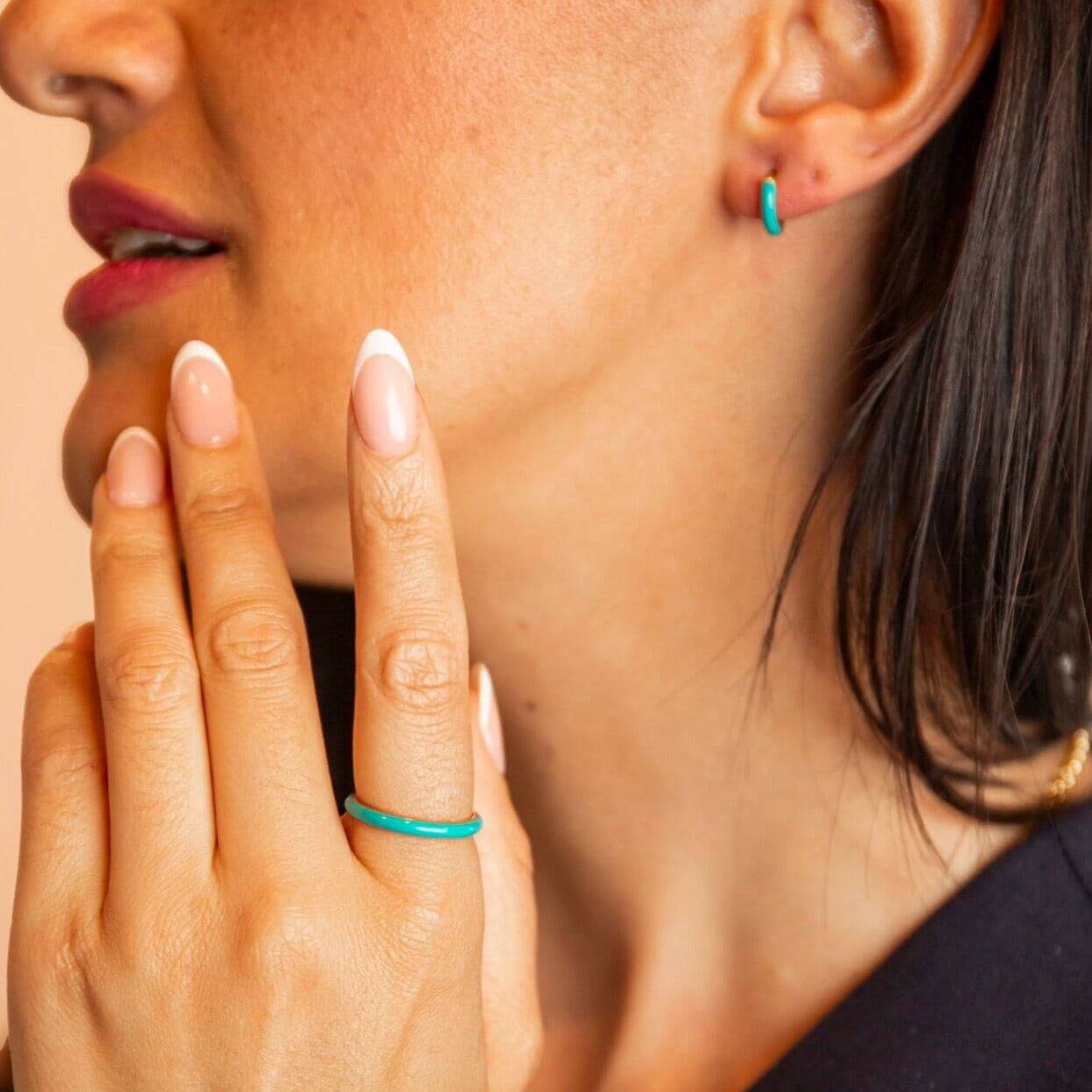 model wears teal enamel and 18k gold vermeil stacking ring