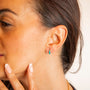 model wears Teal Enamel Huggie Hoop Earrings
