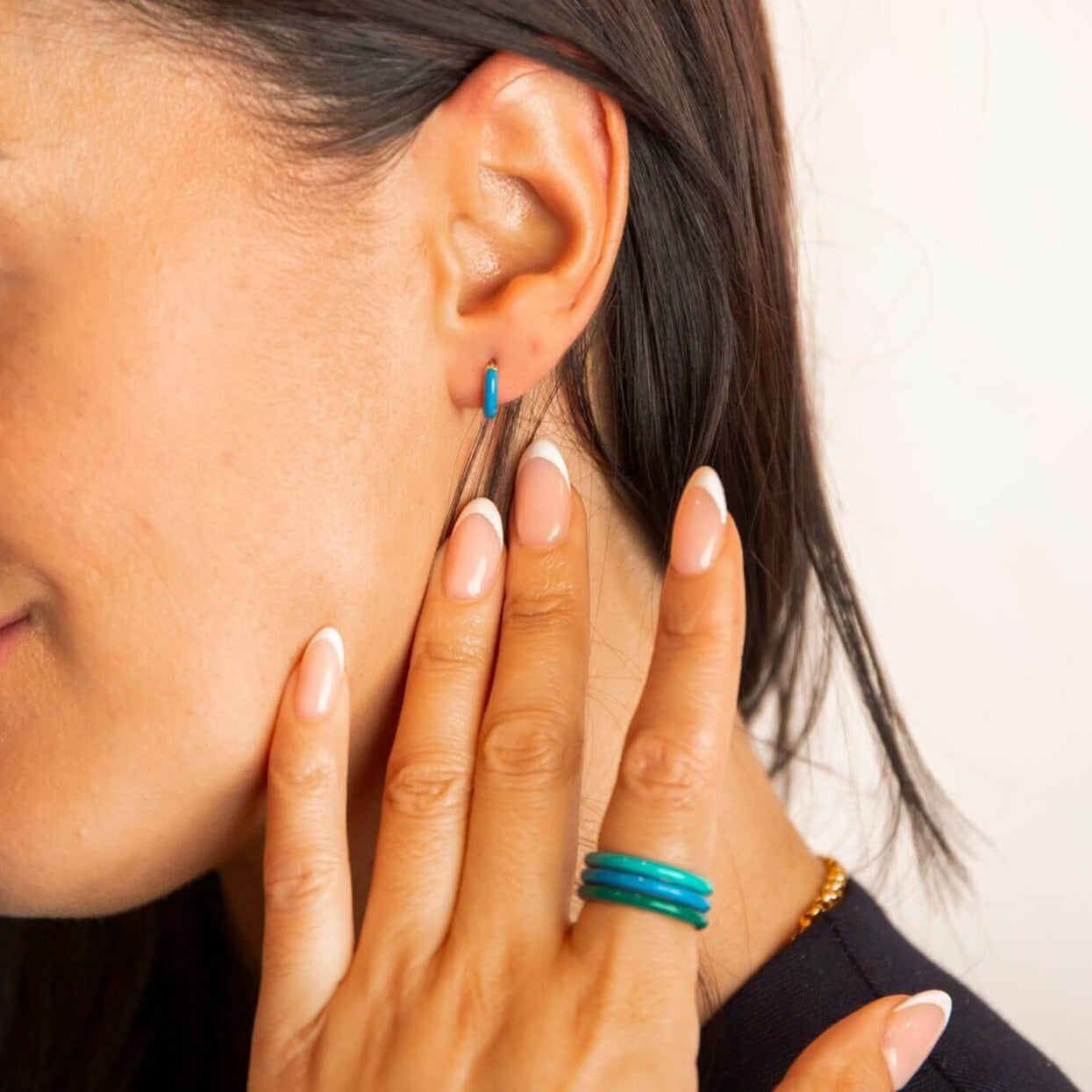 model wears 18k gold vermeil and blue enamel huggie hoop earrings