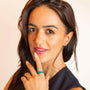 model wears enamel stacking rings in teal, green and blue 