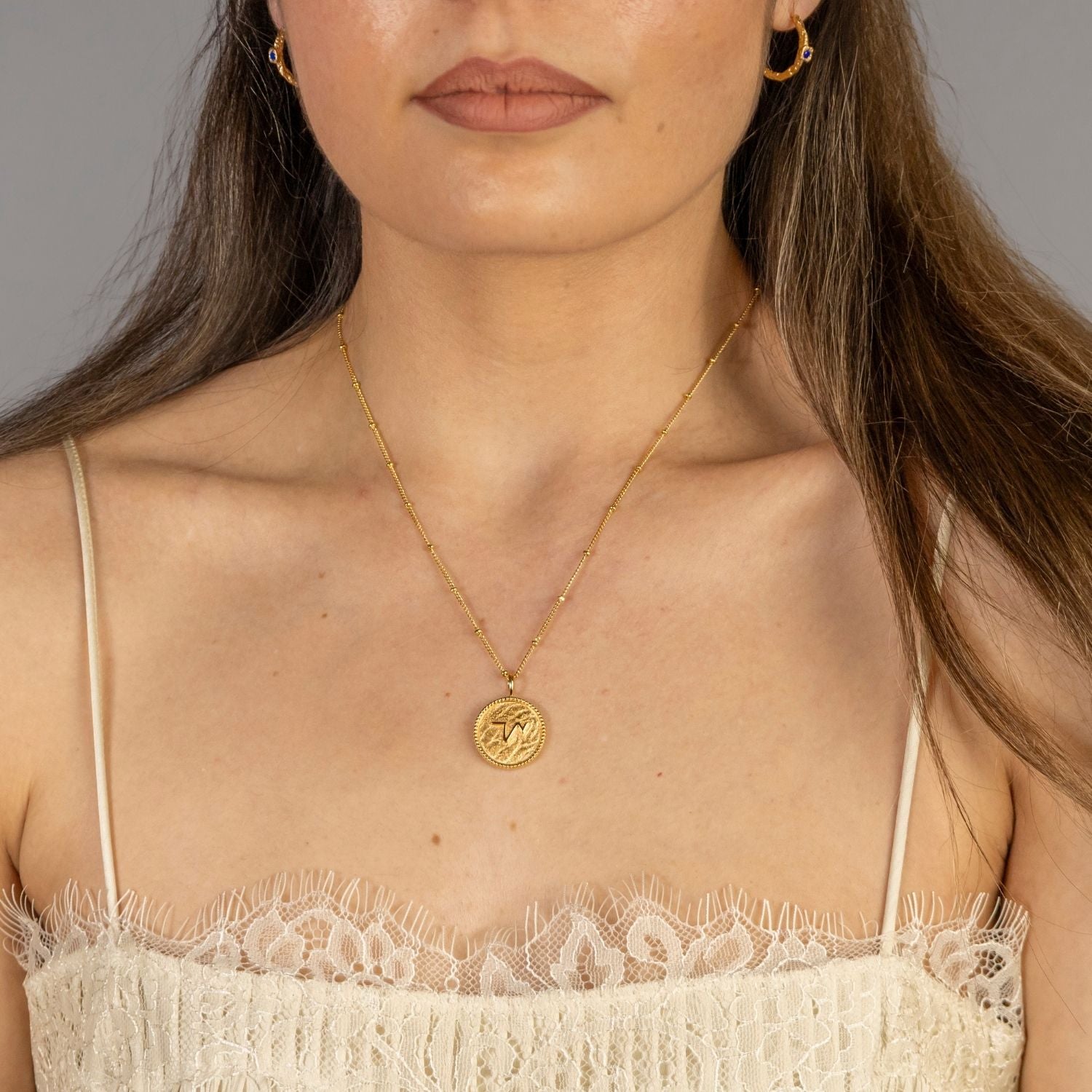 model-wears "Thrive" Gold Coin Necklace