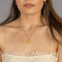 model-wears "Thrive" Gold Coin Necklace