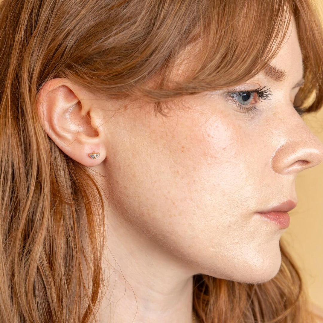 model wears triple cubic zirconia and 18k gold vermeil labret stud earring