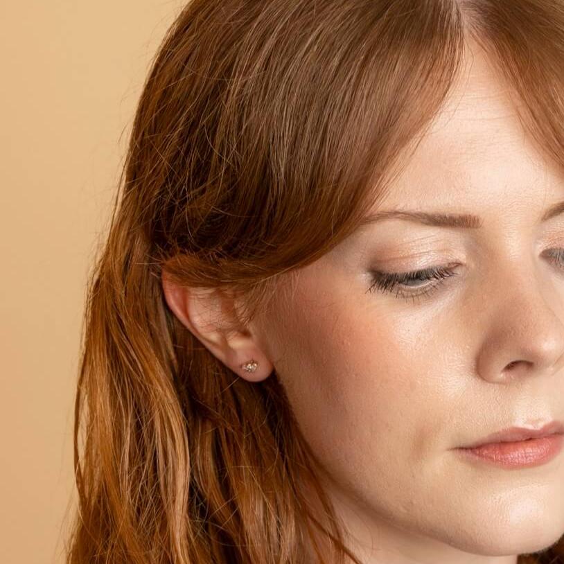 model wears 18k gold vermeil triple cz flat back labret stud earring