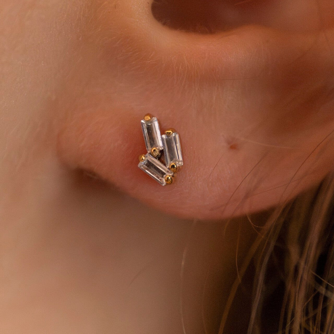 model wears triple cz 18k gold vermeil labret stud earrings 