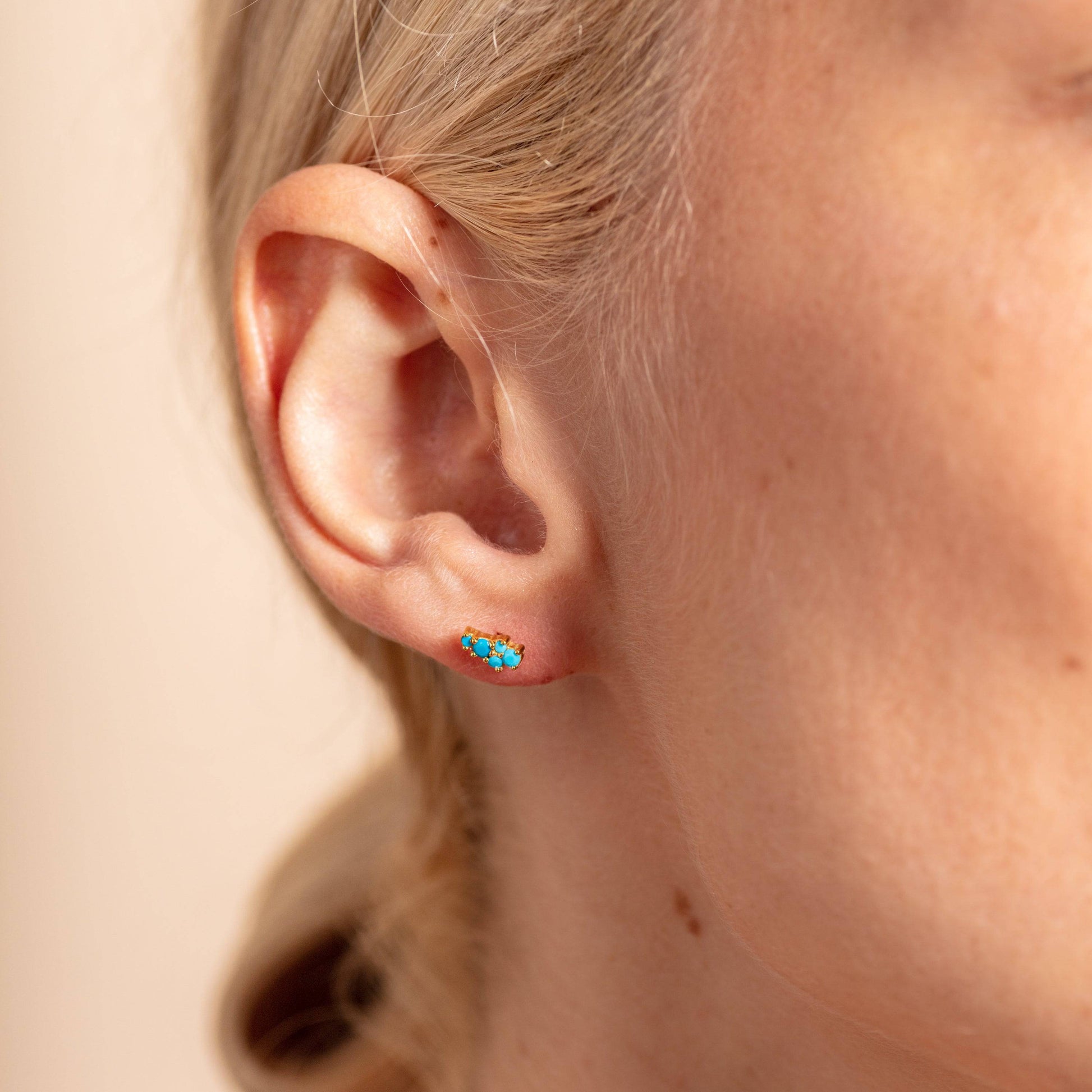 model wears Turquoise and Gold Galaxy Mini Stud Earrings close up