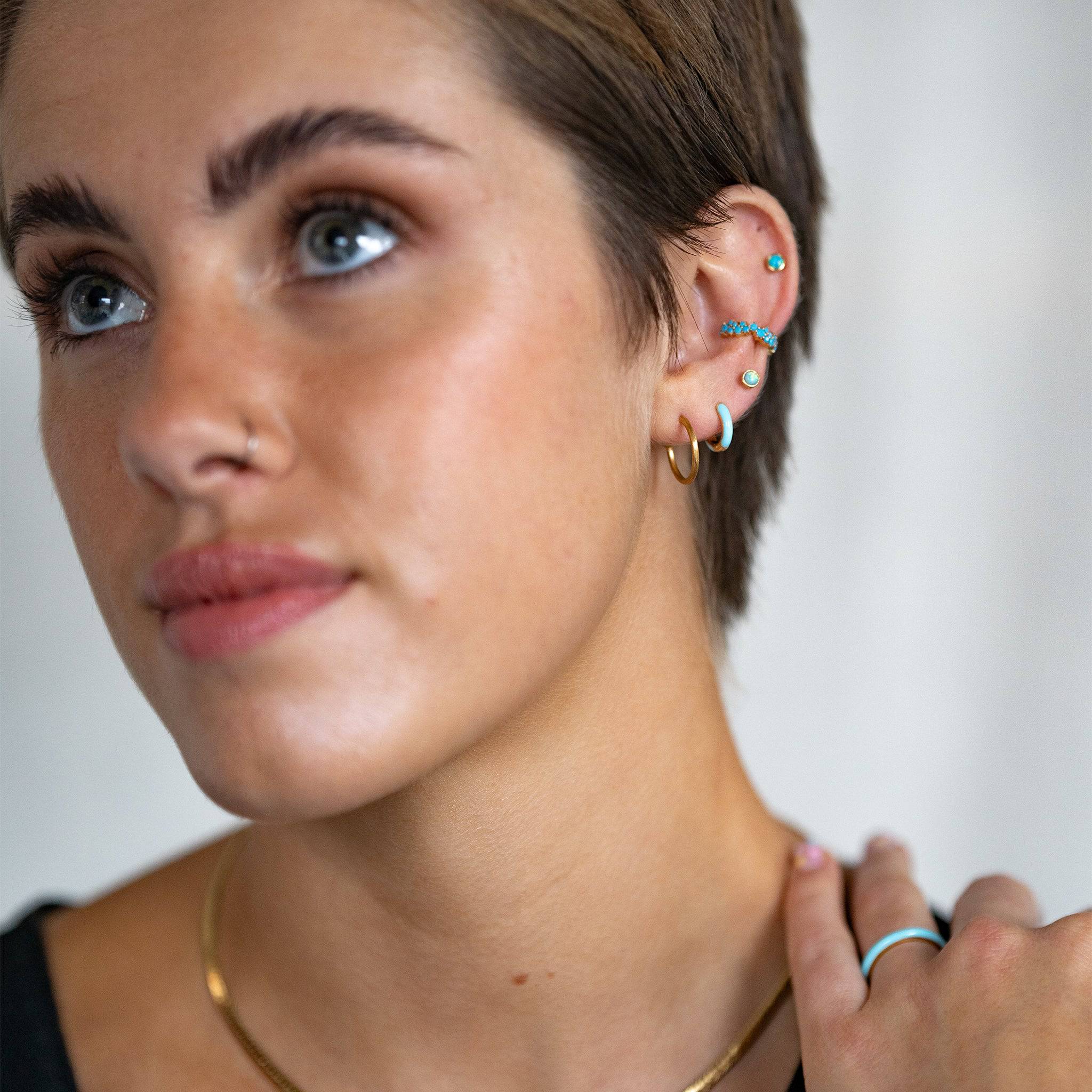 model wears Turquoise Enamel Gold Huggie Earrings and gold vermeil mixed hoop and stud earring ear stack