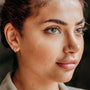 model wears White Opal and Gold Vermeil Huggies