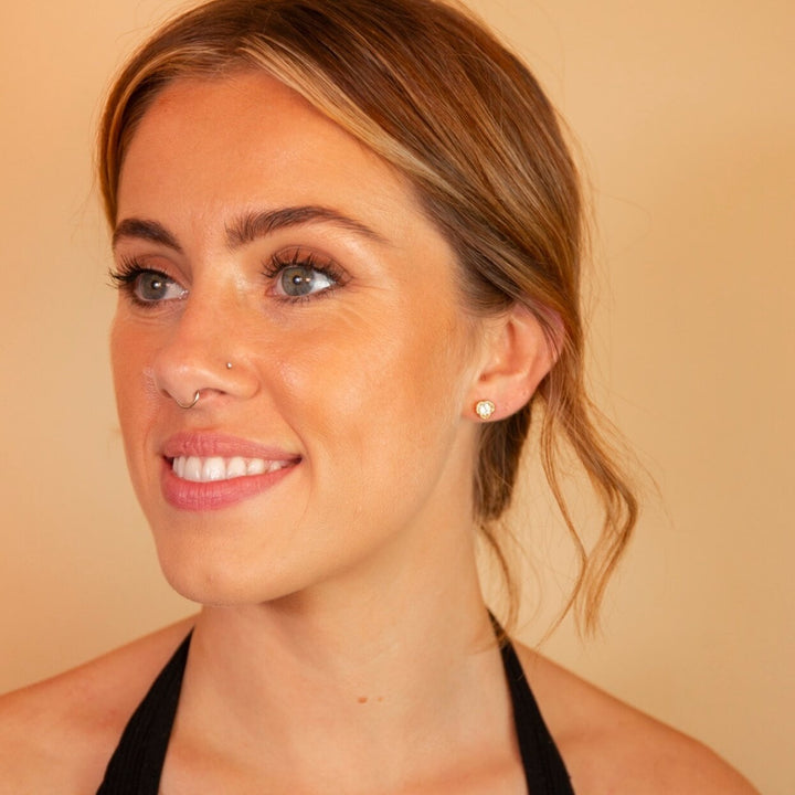 model wears White Topaz Gold Lichen Stud Earrings