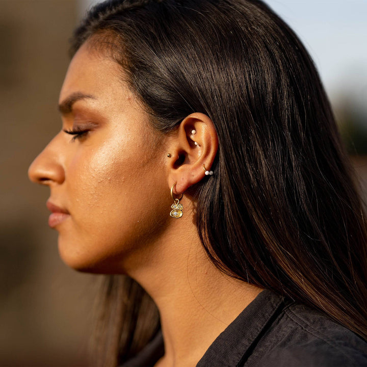 model wears White Topaz  Gold Lichen Hoop Earrings