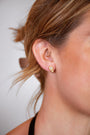 model wears White Topaz Gold Climber Stud Earrings