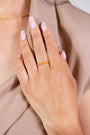 model wears coral enamel ring