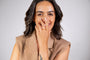 model wears coral enamel ring and coral enamel huggie hoop earrings