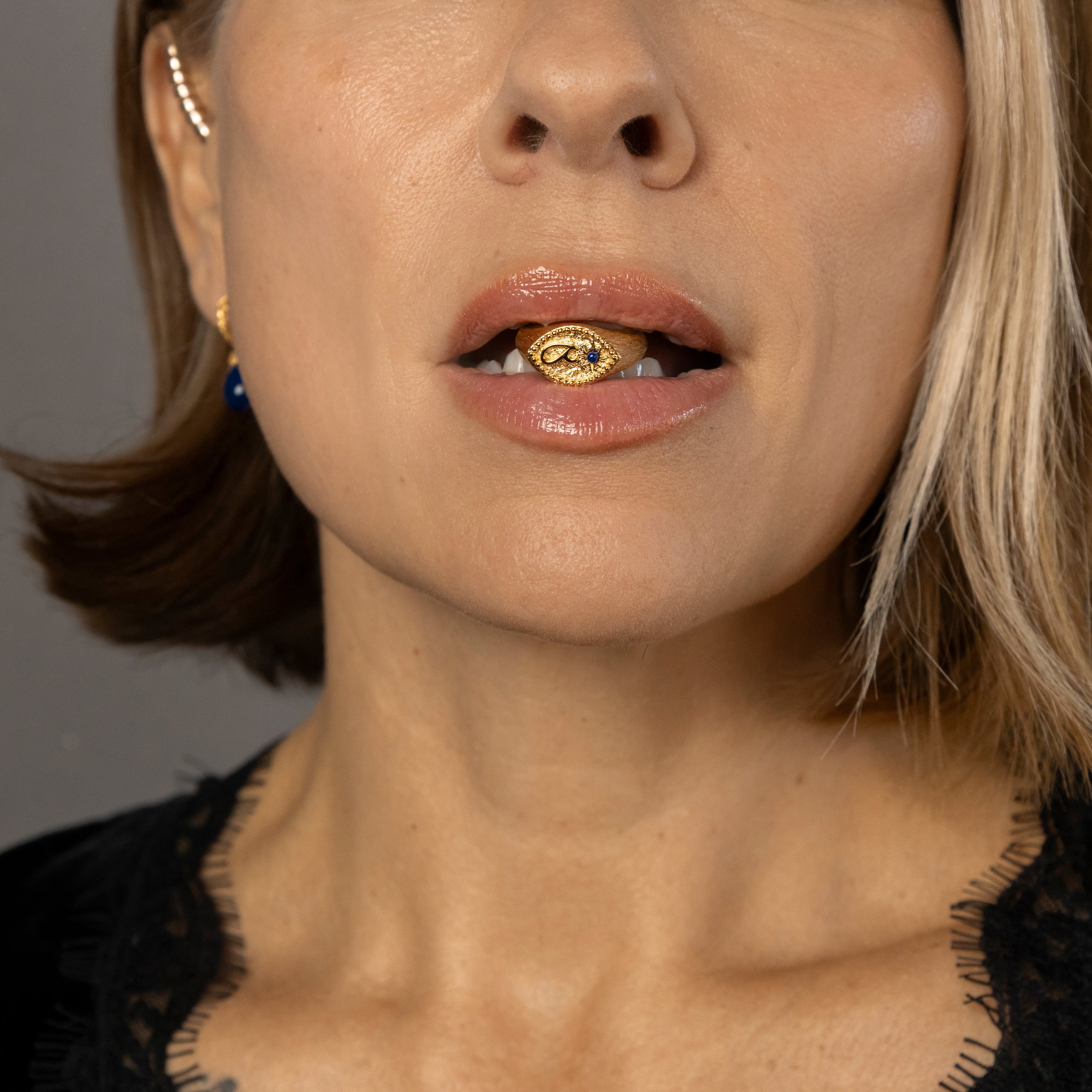 Nadia holds gold Fuck Ring in her mouth 