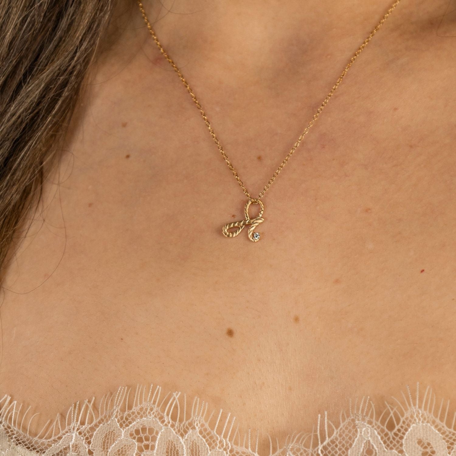 model wears Fearless Gold Shorthand Charm Necklace
