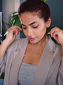 model puts on an 18k gold vermeil brushed north star necklace