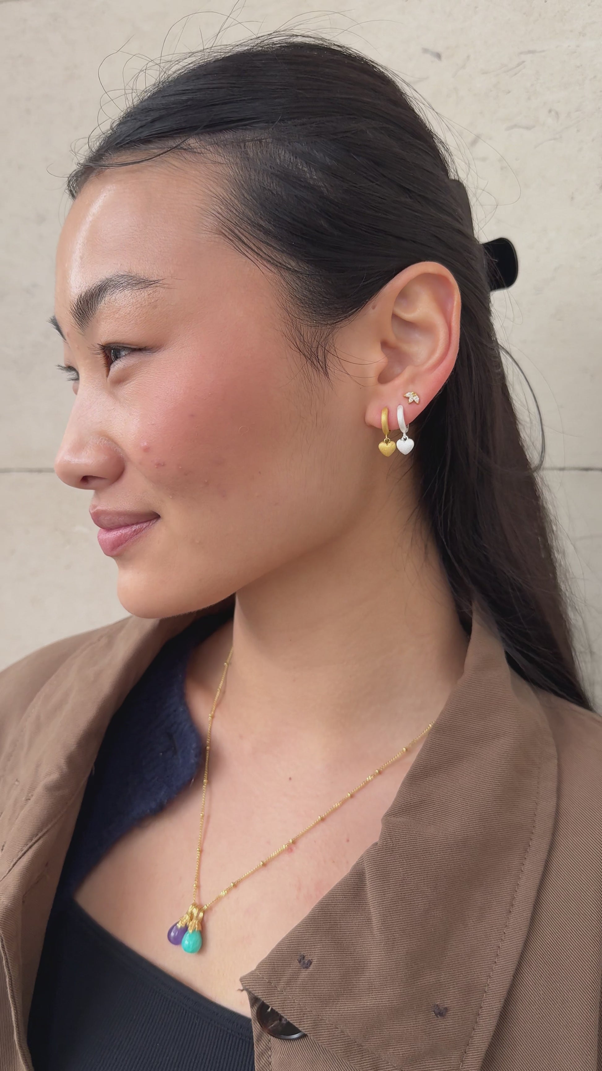 Jade wears Brushed Heart Silver Huggie Hoops