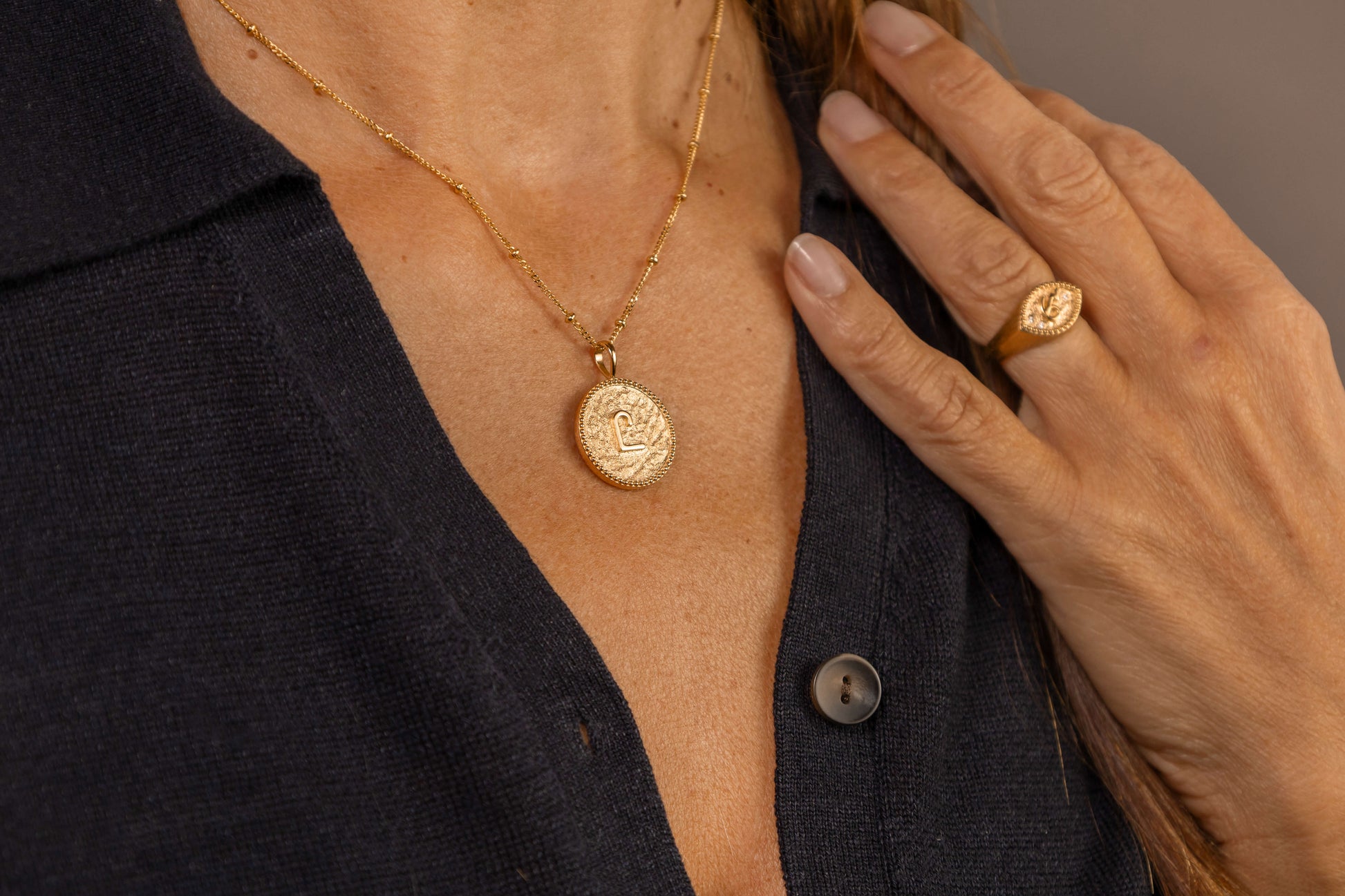 model wears C*** Gold Shorthand Coin Necklace