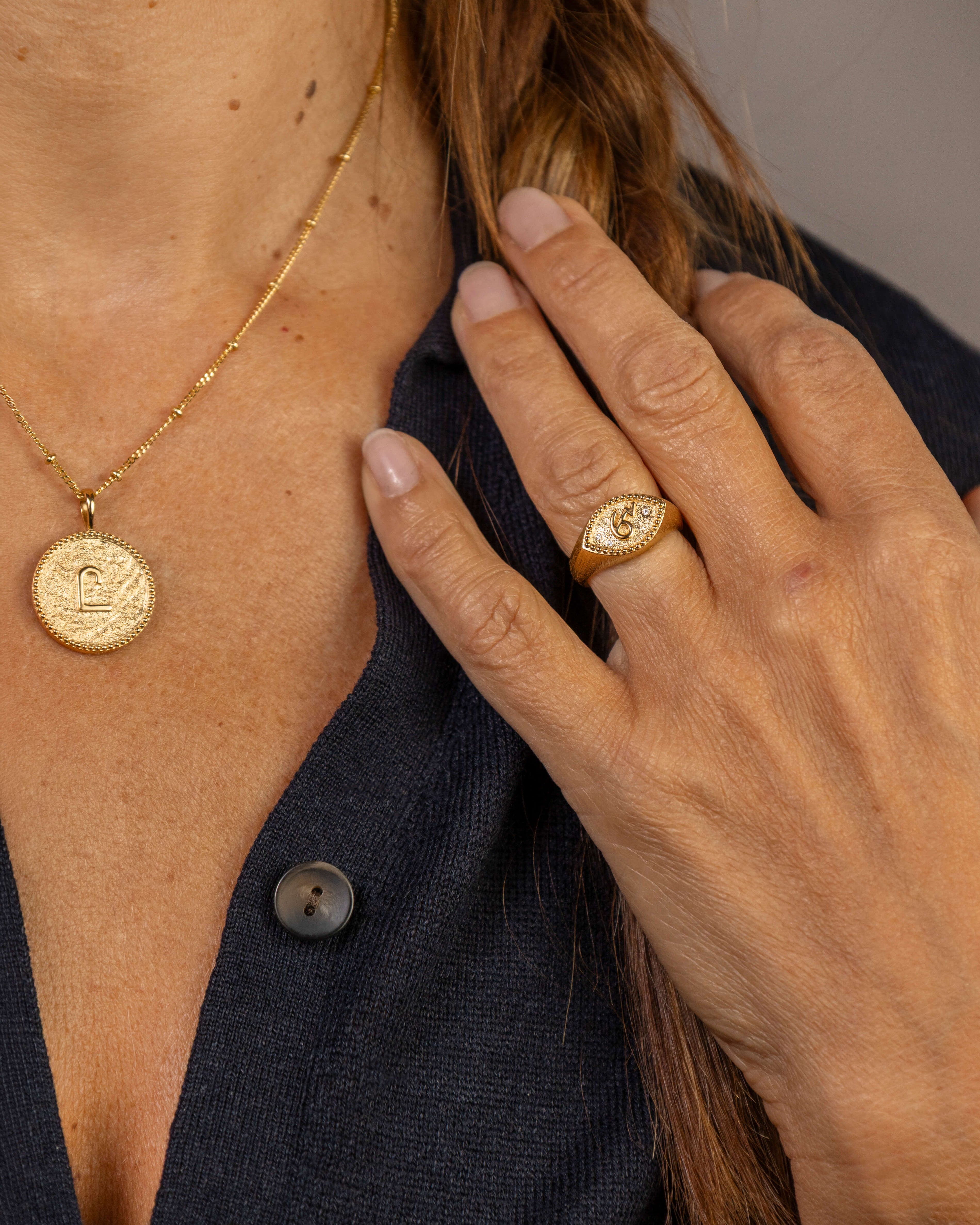 model wears C*** Gold Shorthand Coin Necklace