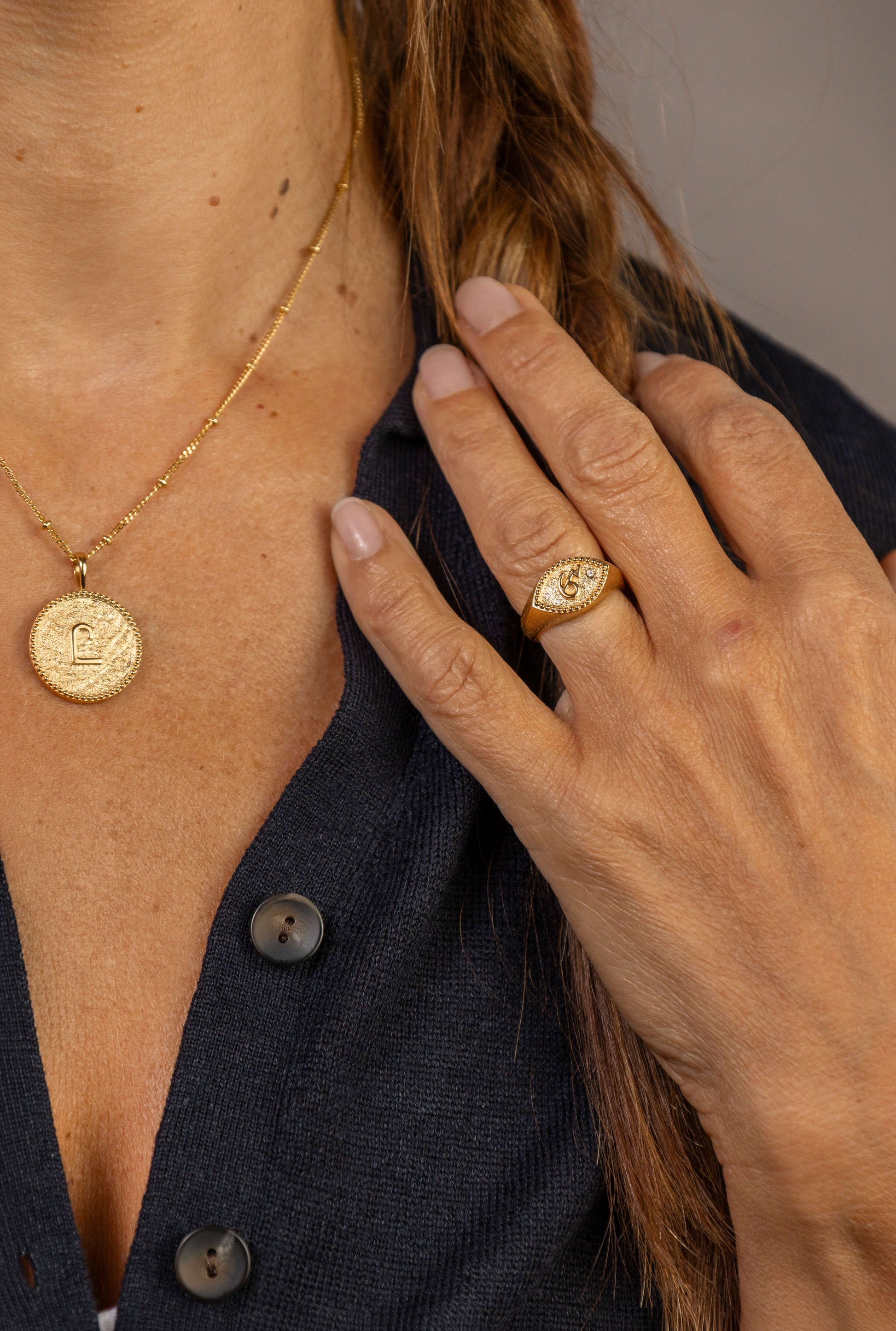 model wears C*** Gold Shorthand Coin Necklace